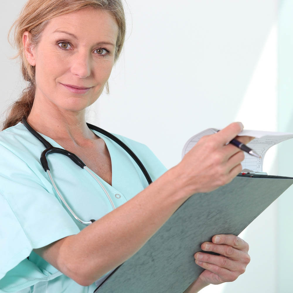 A female nurse viewing a medical chart