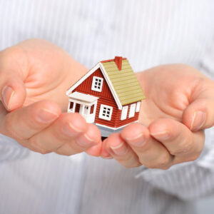 Miniture home model being held in a person's hands