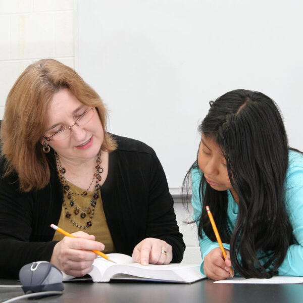 A woman teaching a young girl