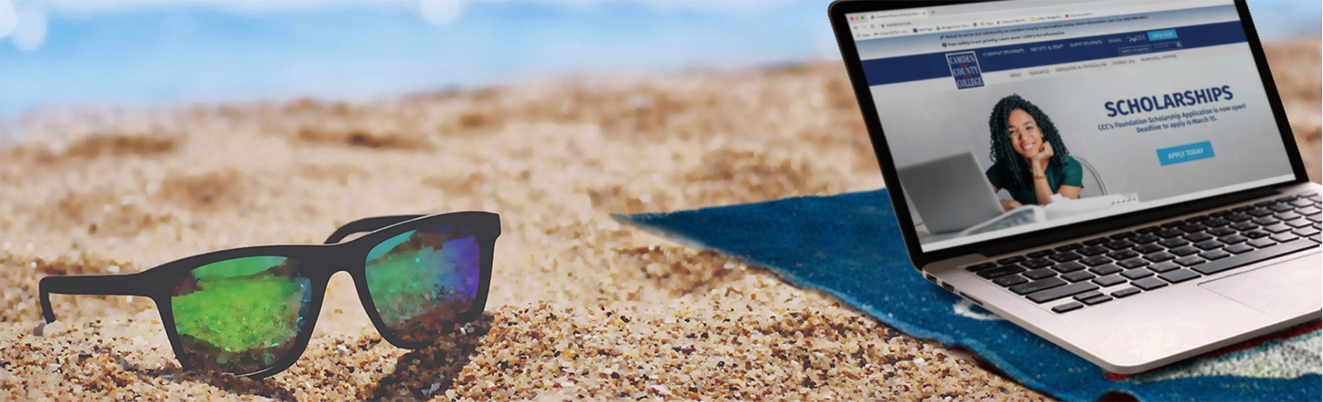 sunglasses and laptop on the beach
