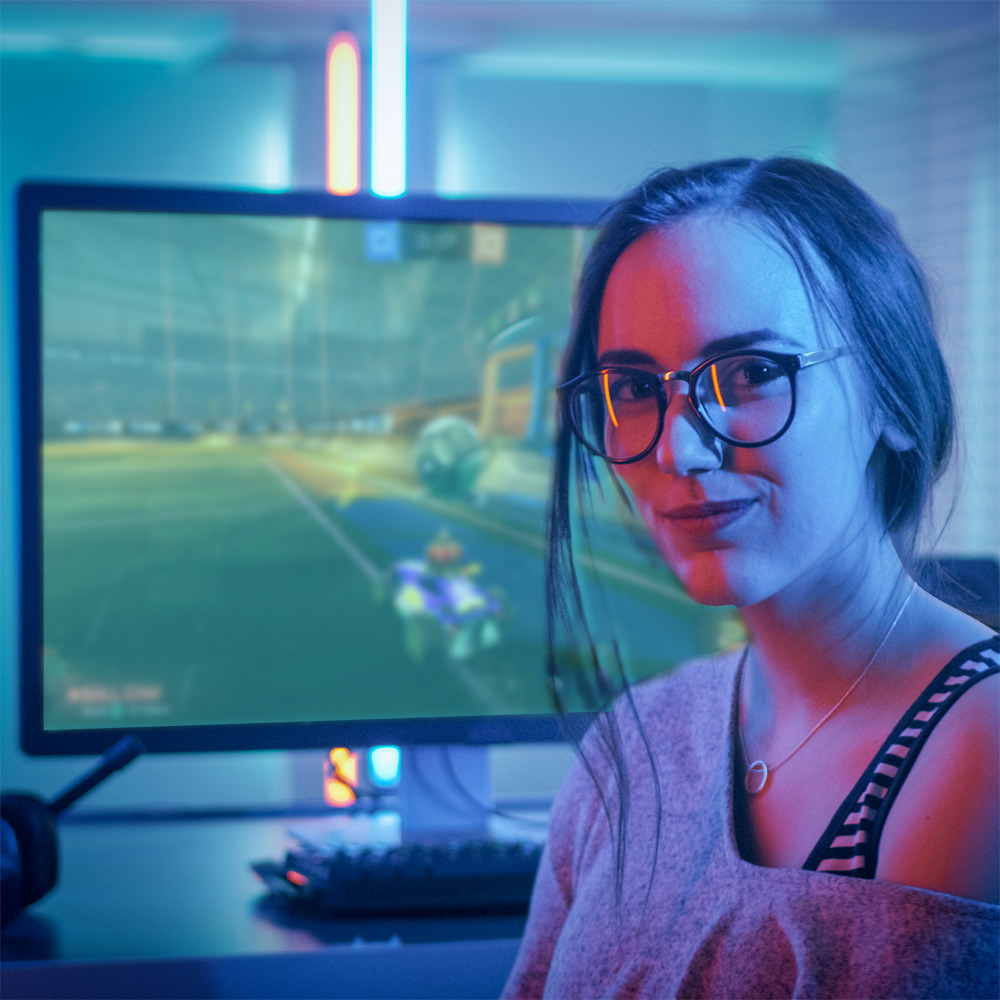young woman sitting in front of a gaming pc