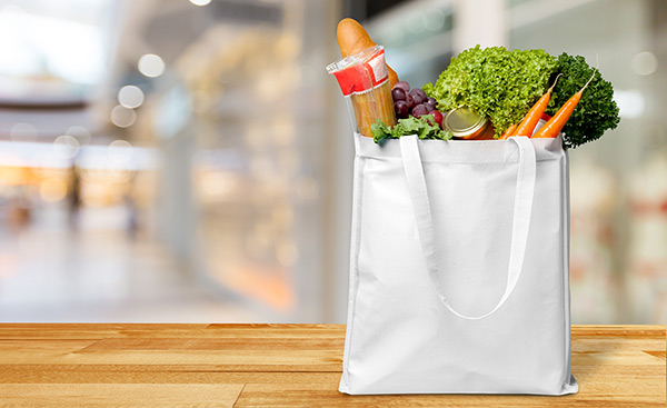 fresh groceries placed in a white bag