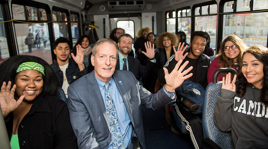 Presudent Don Borden with students on the Campus Shuttle