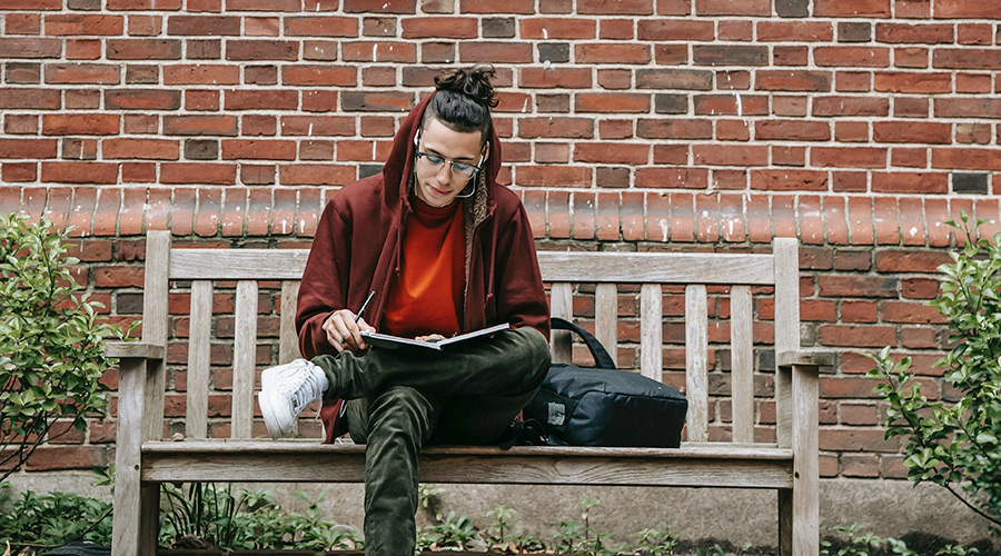 student studying on a bench
